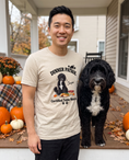 Load image into Gallery viewer, Dinner Patrol unisex tee in Heather Sand Dune with a custom Portuguese Water Dog design | Alpha Paw
