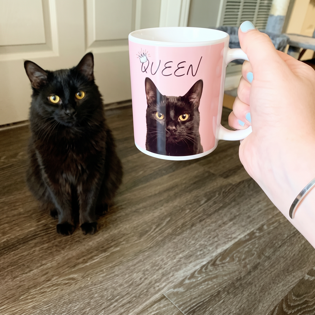 Golden-eyed black cat on a personalized pet coffee mug