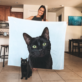 Green-eyed black cat on a personalized photo fleece blanket